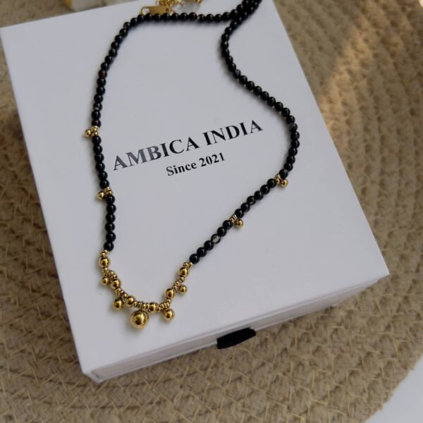 Black stone with gold pearl necklace